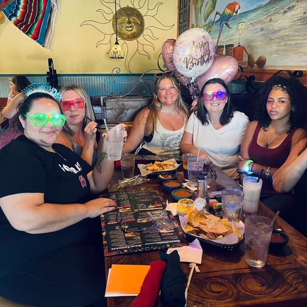Five women celebrating a birthday at Chaparral Mexican and Cuban Restaurant, with chips, salsa, and drinks.